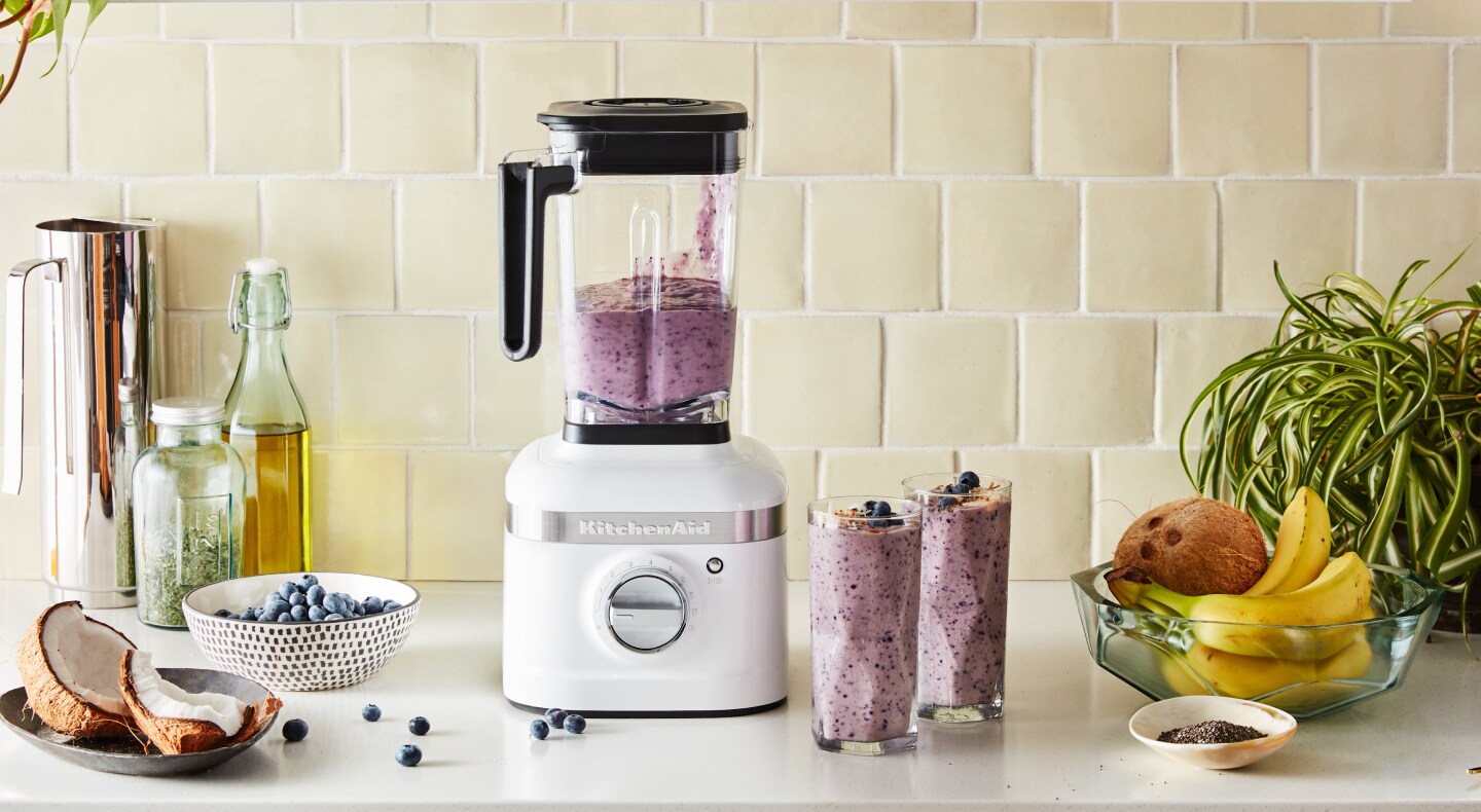 KitchenAid® blender on countertop with blueberries and bananas KitchenAid® blender on countertop with blueberries and bananas