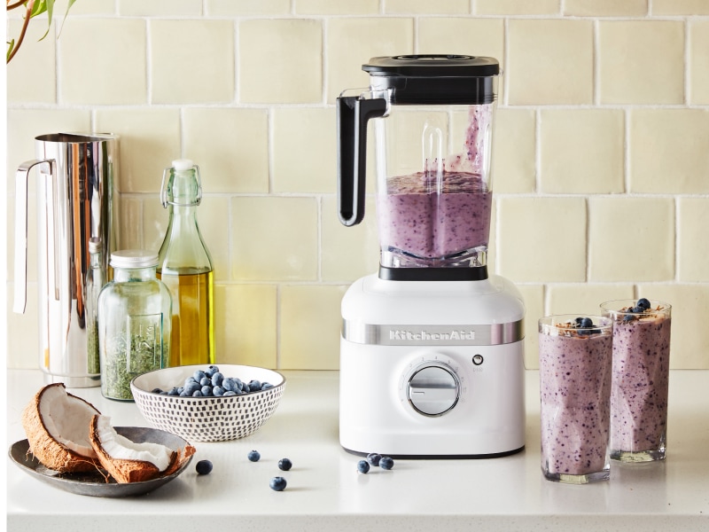KitchenAid® blender on countertop with blueberries and bananas KitchenAid® blender on countertop with blueberries and bananas