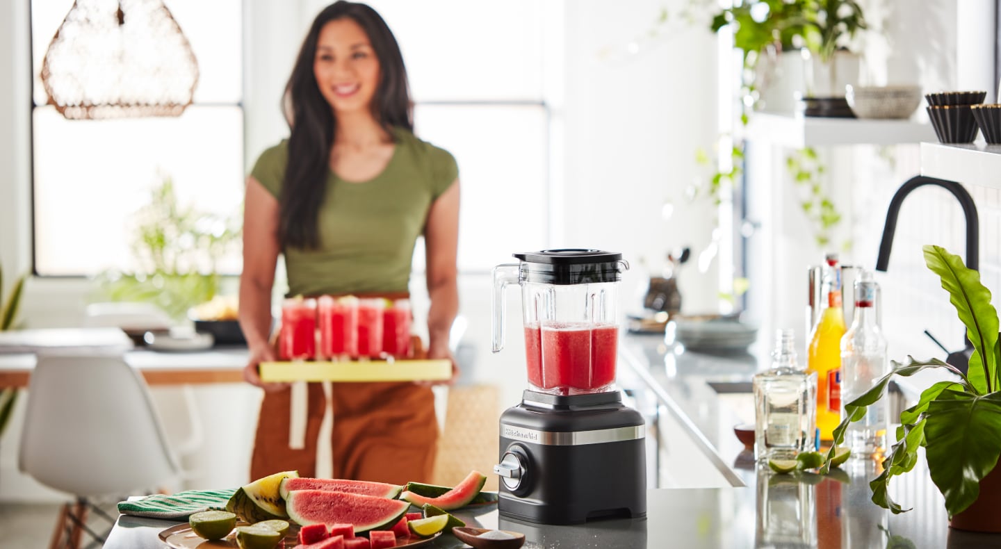 Person with tray of frozen fruit drinks Person with tray of frozen fruit drinks