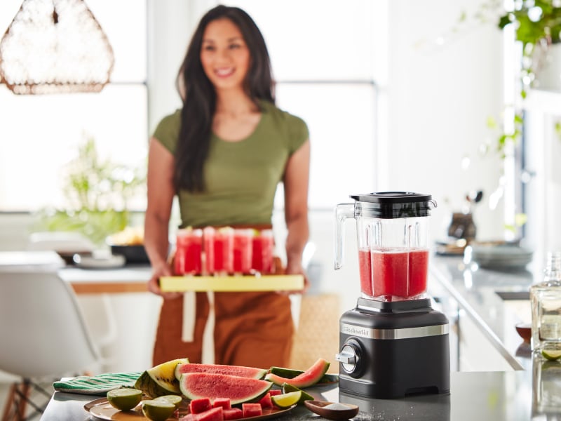 Person with tray of frozen fruit drinks Person with tray of frozen fruit drinks