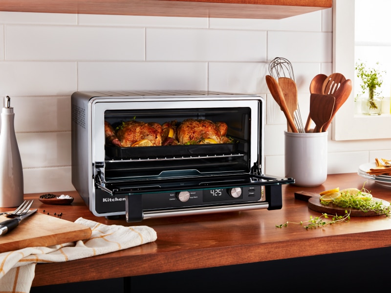Two whole chickens roasting in a KitchenAid® countertop oven Two whole chickens roasting in a KitchenAid® countertop oven