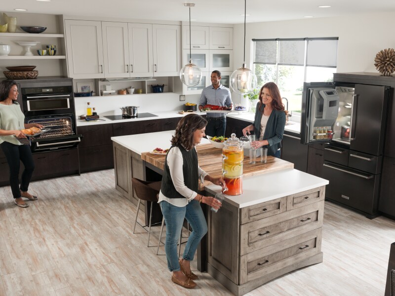 People gathering and cooking in an open concept kitchen