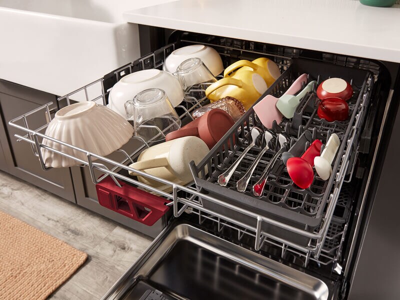 Third rack on a dishwasher with mugs and utensils