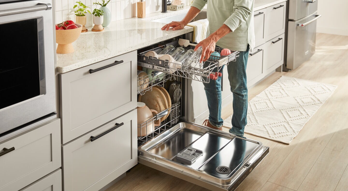 Person unloading third rack on dishwasher