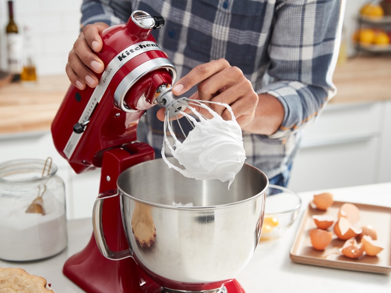 Red KitchenAid® stand mixer making homemade meringue Red KitchenAid® stand mixer making homemade meringue