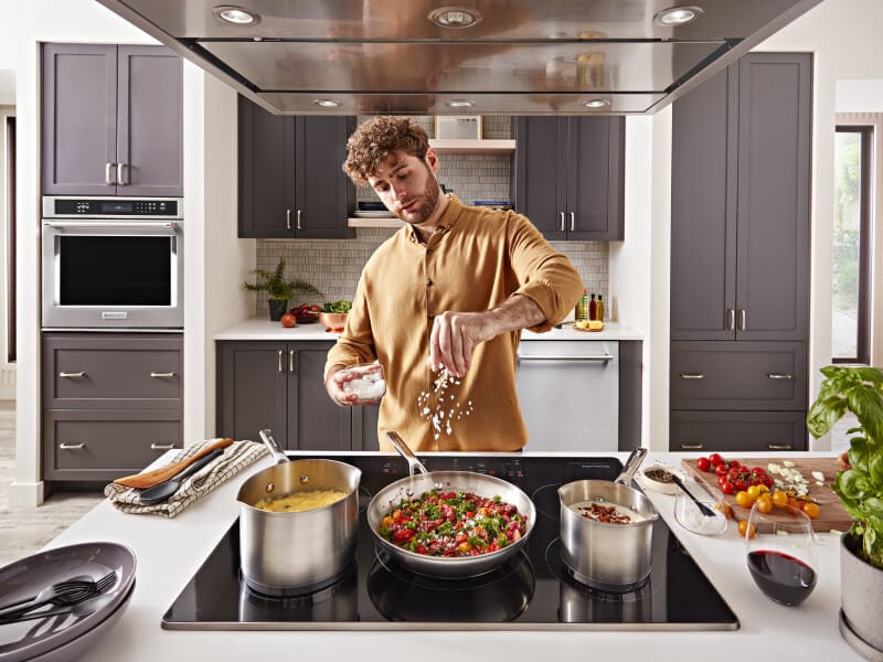 Person cooking on an electric cooktop