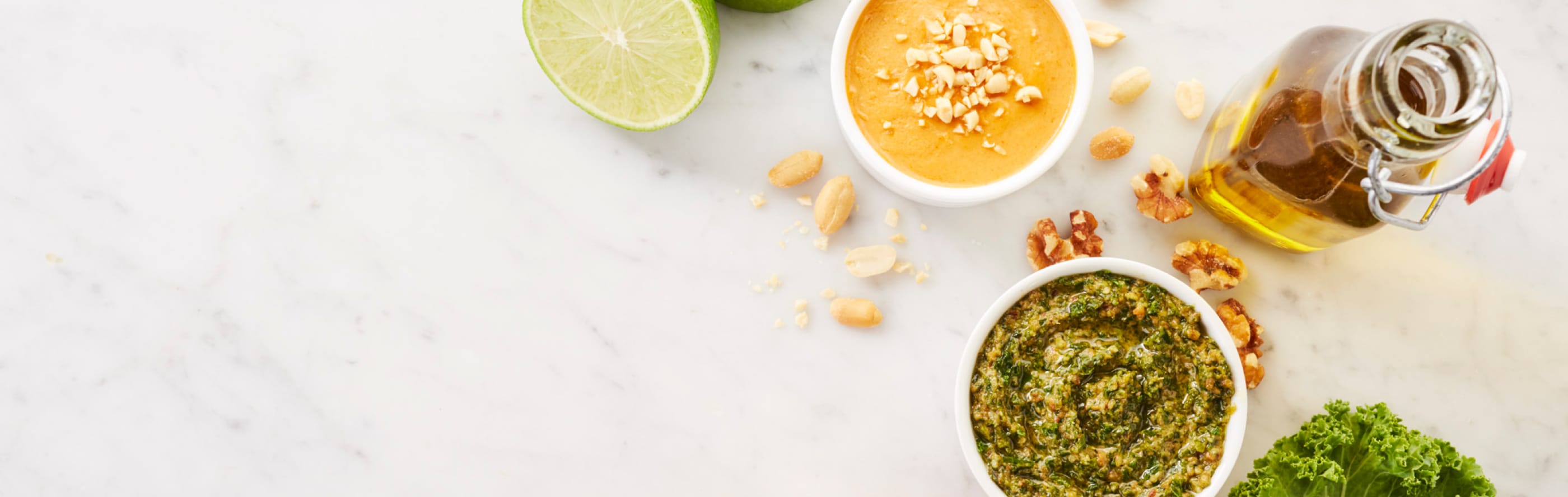 Several sauces and ingredients resting on a marble countertop