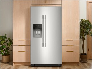 A KitchenAid® refrigerator surrounded by brown cabinetry