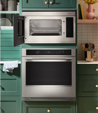A KitchenAid® wall oven surrounded by teal cabinetry