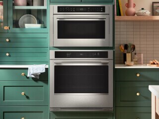 A KitchenAid® wall oven surrounded by green cabinetry