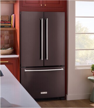 A KitchenAid® refrigerator surrounded by brown cabinetry