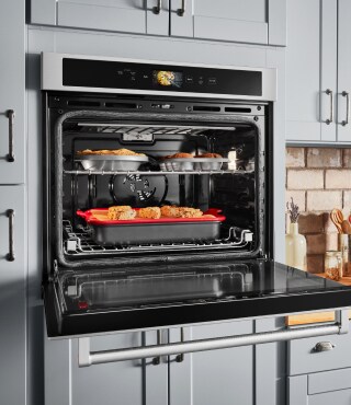 Trays of food roasting in an oven