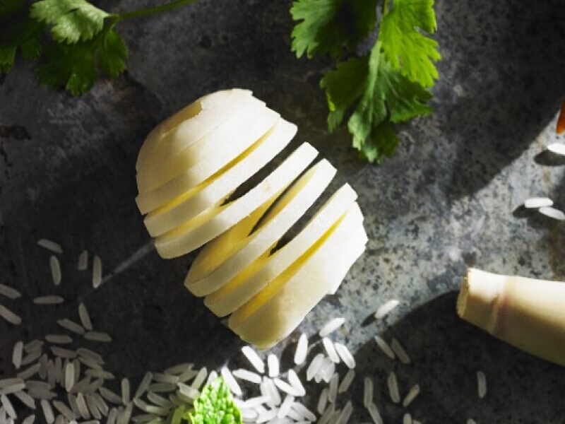 Spiral sliced potatoes on countertop with ingredients