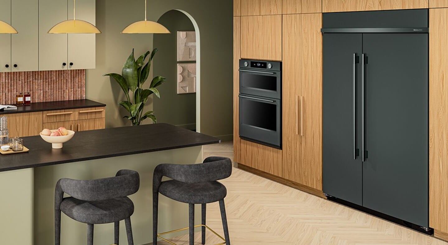 Suite of KitchenAid® Juniper appliances in natural wood cabinetry