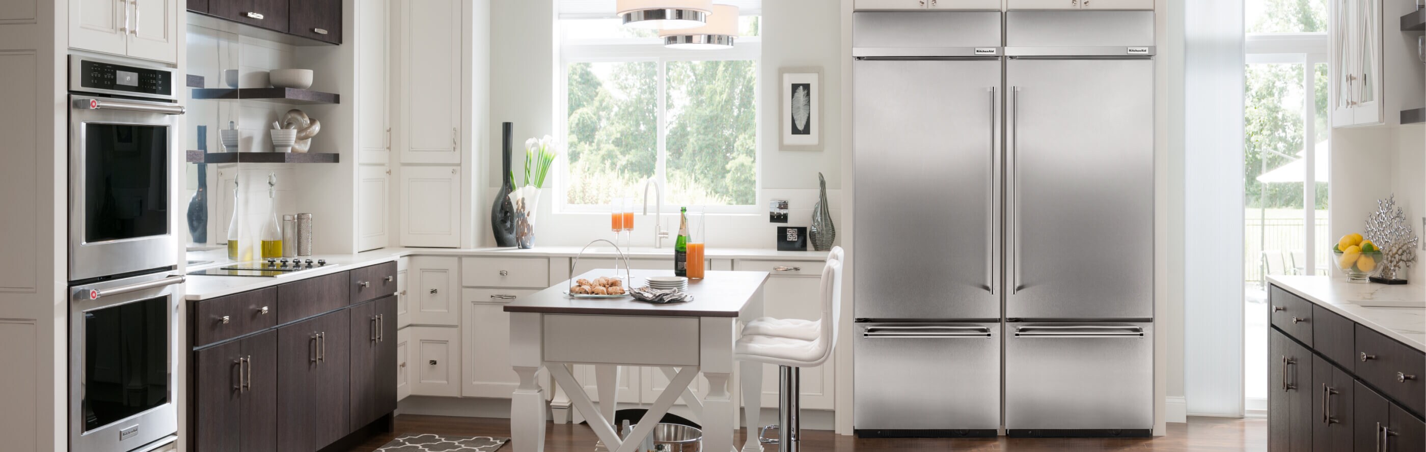 Stainless steel KitchenAid® refrigerator built into a modern kitchen