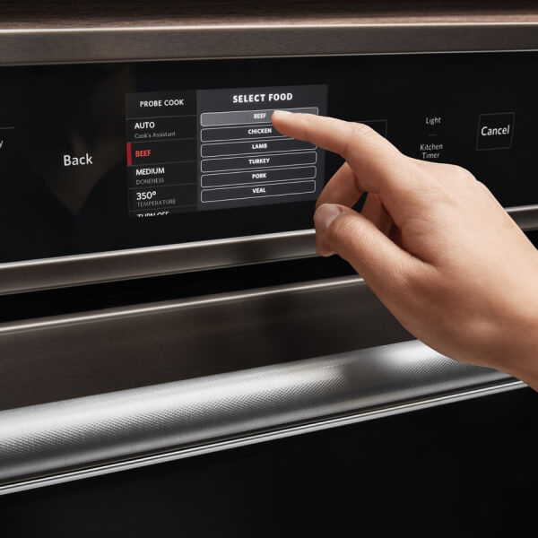 Finger pushing a setting on a convection oven