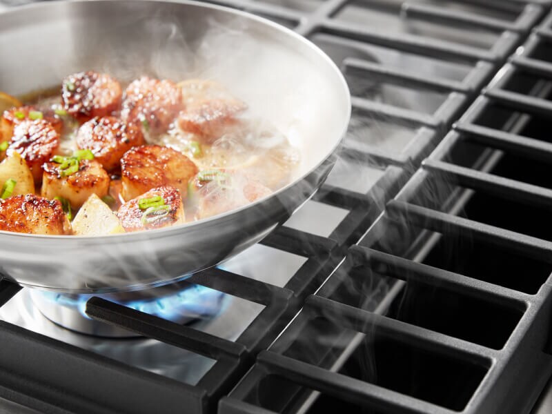 Downdraft hood sucking up smoke from scallops cooking on a downdraft gas range Downdraft hood sucking up smoke from scallops cooking on a downdraft gas range
