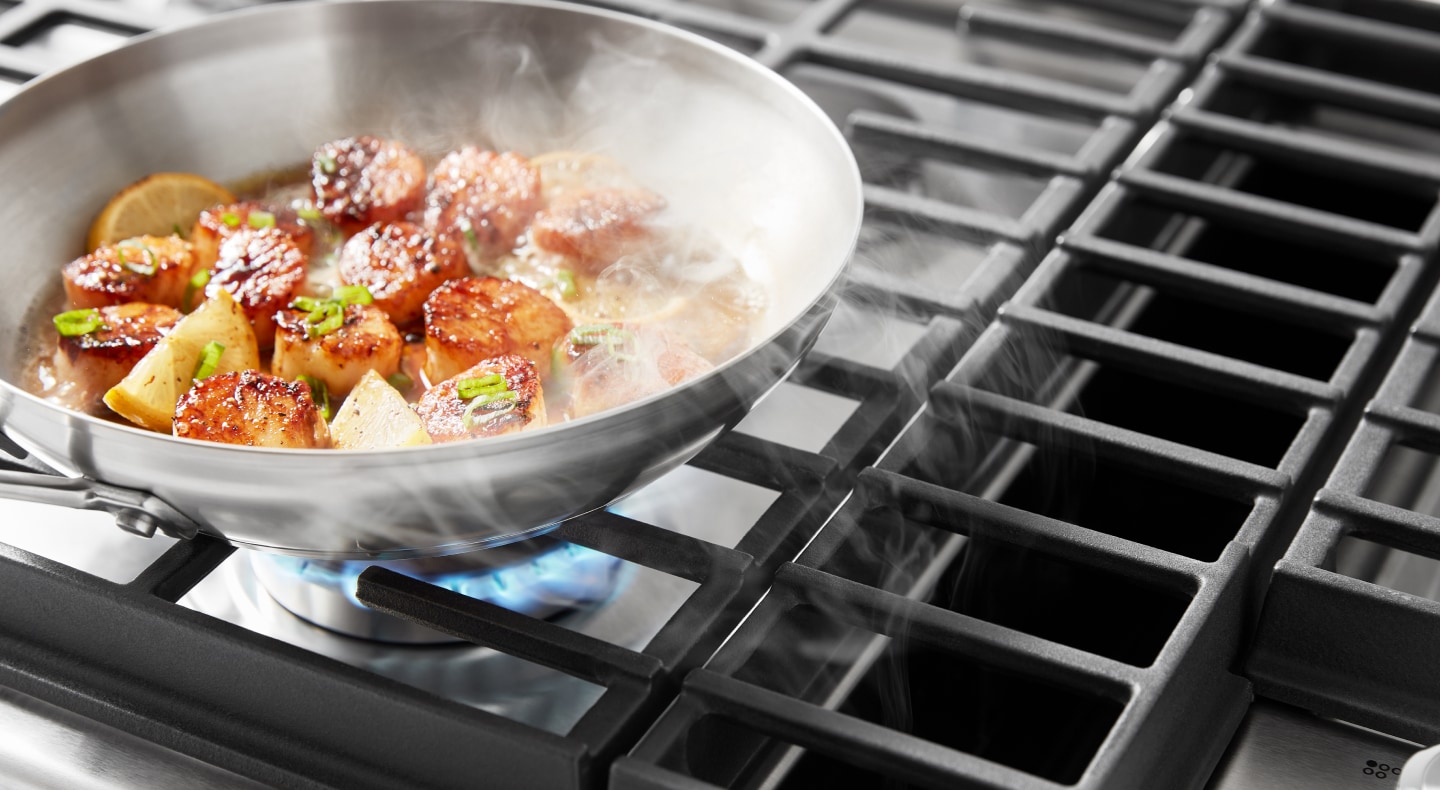 Downdraft hood sucking Downdraft hood sucking up smoke from scallops cooking on a downdraft gas range up smoke from food cooking on the range Downdraft hood sucking up smoke from scallops cooking on a downdraft gas range