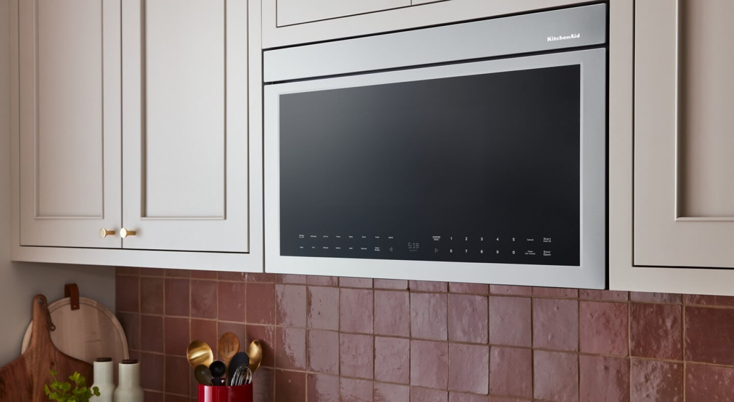 A KitchenAid® microwave above a stovetop A KitchenAid® microwave above a stovetop