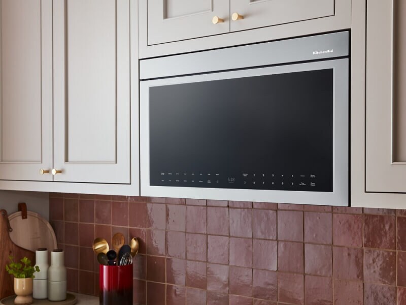 A KitchenAid® microwave above a stovetop A KitchenAid® microwave above a stovetop