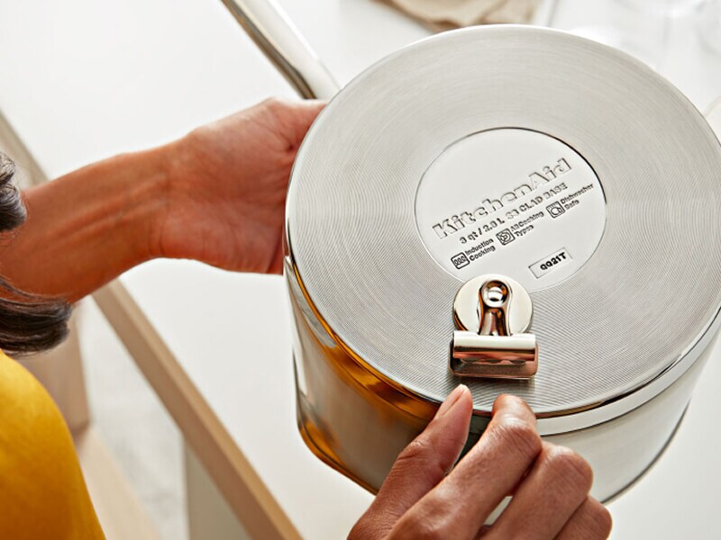 Person performing magnet test on KitchenAid® cookware Person performing magnet test on KitchenAid® cookware