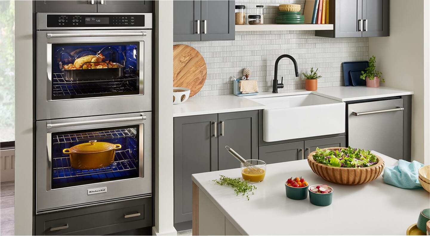 A KitchenAid® double wall oven inside of a bright kitchen