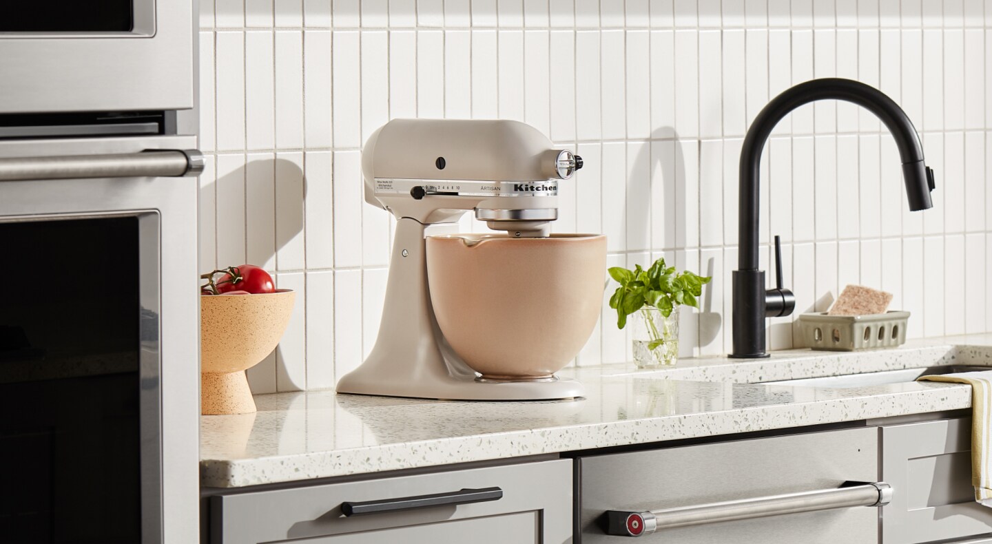 Cream KitchenAid® stand mixer with a beige mixing bowl Cream KitchenAid® stand mixer with a beige mixing bowl