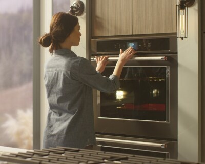 Person selecting settings on a double wall oven