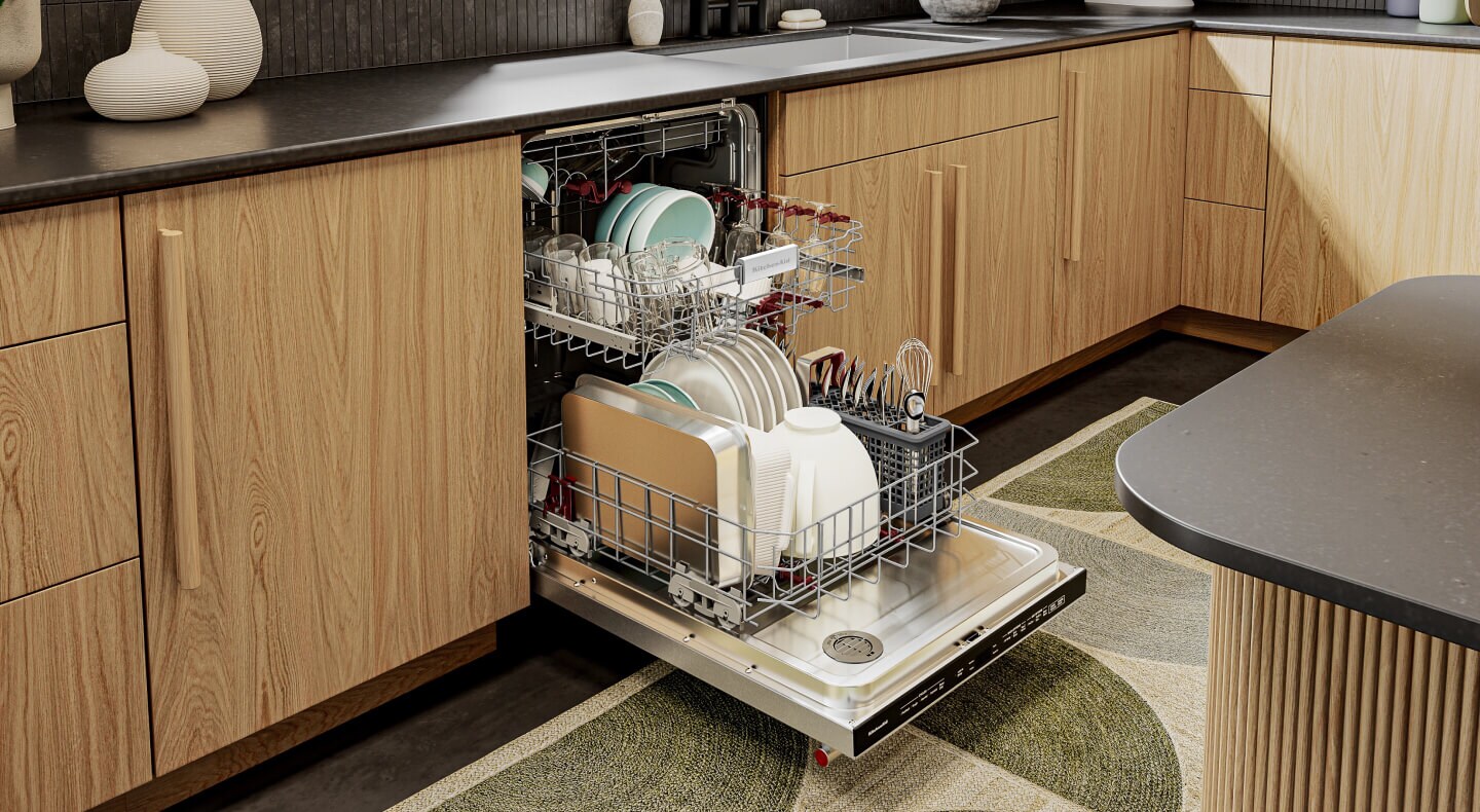 Open KitchenAid® dishwasher with bottom rack pulled out and loaded