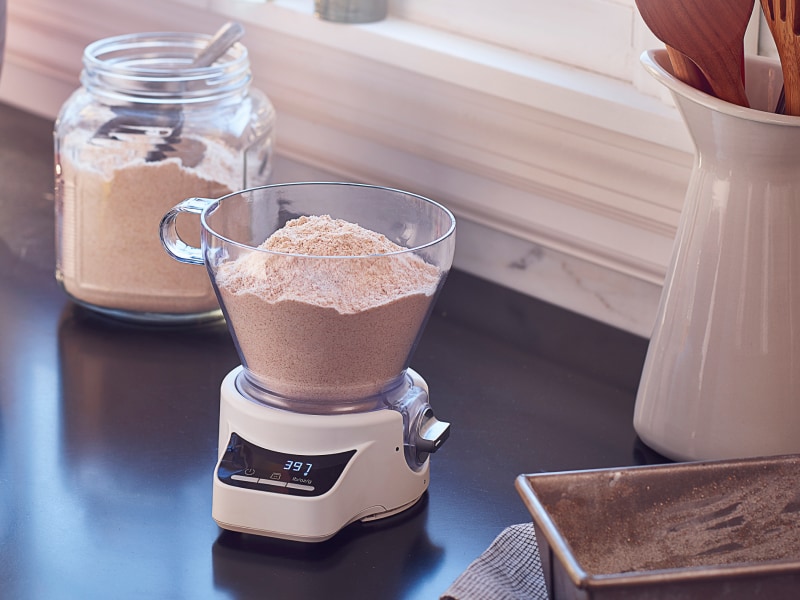 A red KitchenAid® stand mixer amongst a food scale and various baking ingredients A red KitchenAid® stand mixer amongst a food scale and various baking ingredients