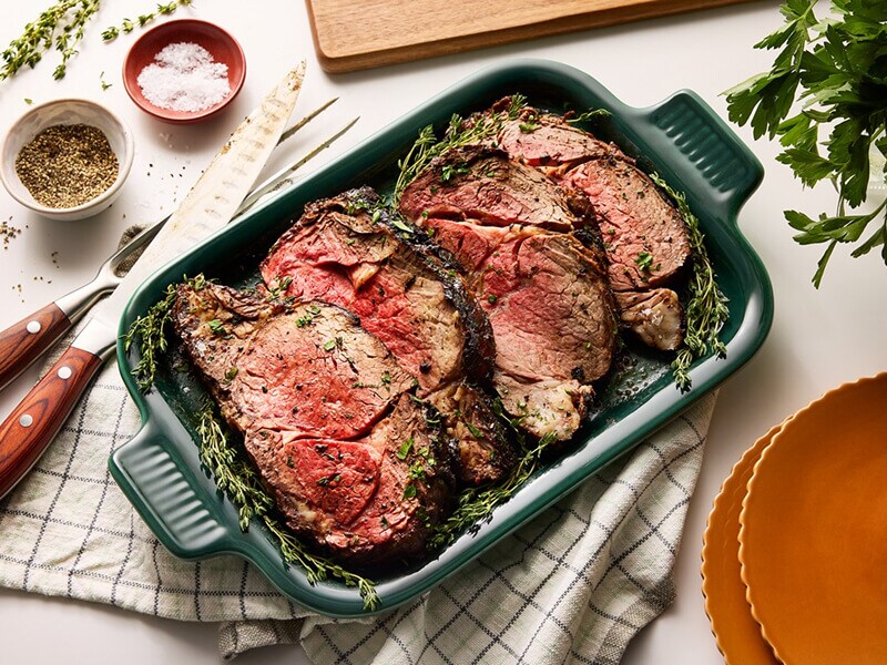 Herb-seasoned meat in a casserole pan Herb-seasoned meat in a casserole pan
