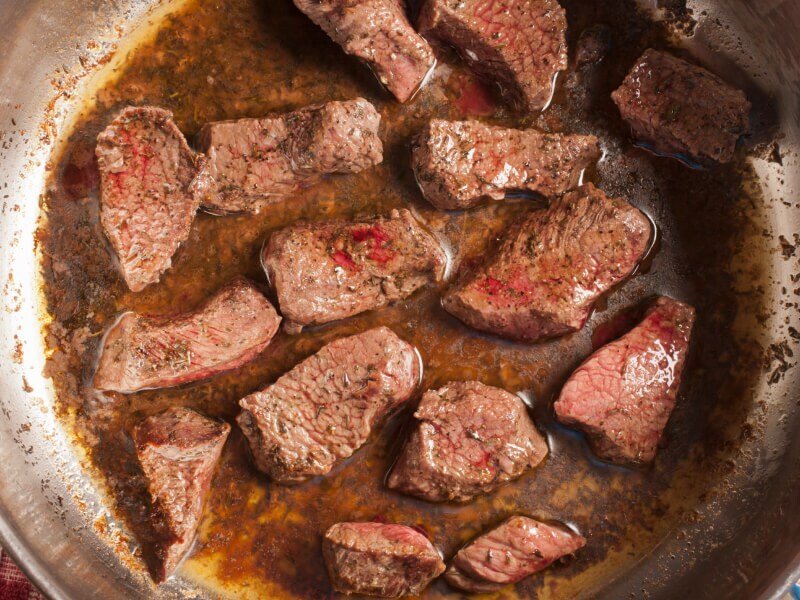Meat browning in a pot