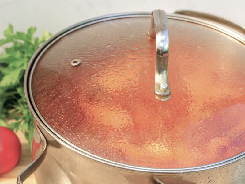 A pot simmering with a lid on