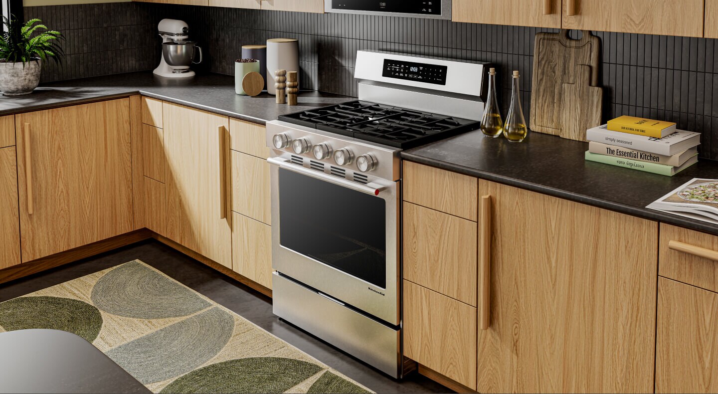 A kitchen with wood cabinetry and a KitchenAid® gas range