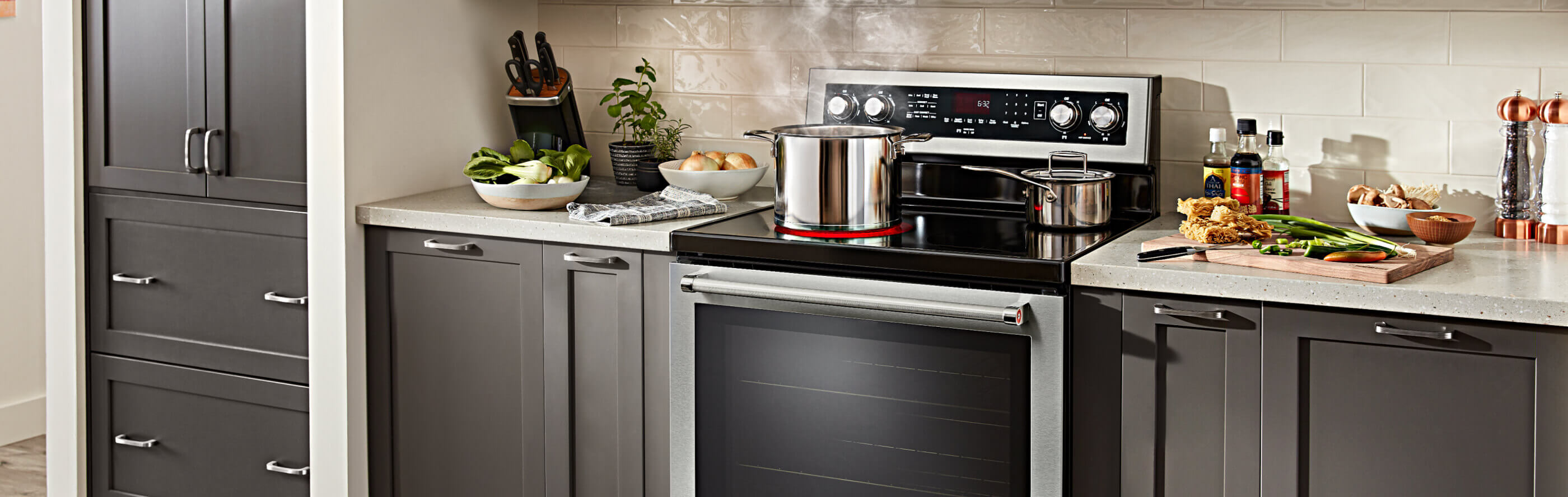 A kitchen with various pots on a range