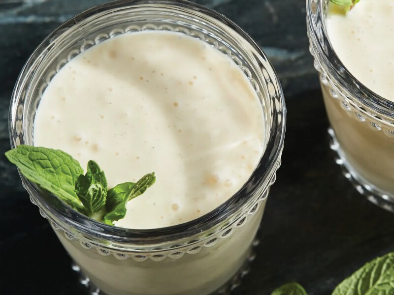Close-up of white smoothie garnished with mint leaves Close-up of white smoothie garnished with mint leaves
