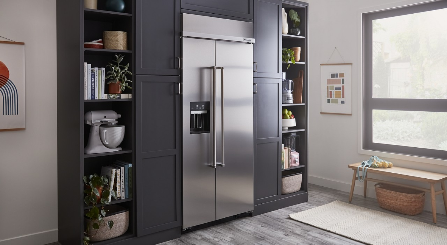 Built-in stainless steel KitchenAid® side-by-side refrigerator in gray-blue cabinetry Built-in stainless steel KitchenAid® side-by-side refrigerator in gray-blue cabinetry