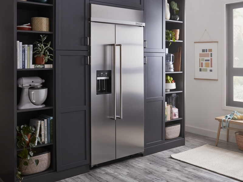 Built-in stainless steel KitchenAid® side-by-side refrigerator in gray-blue cabinetry Built-in stainless steel KitchenAid® side-by-side refrigerator in gray-blue cabinetry