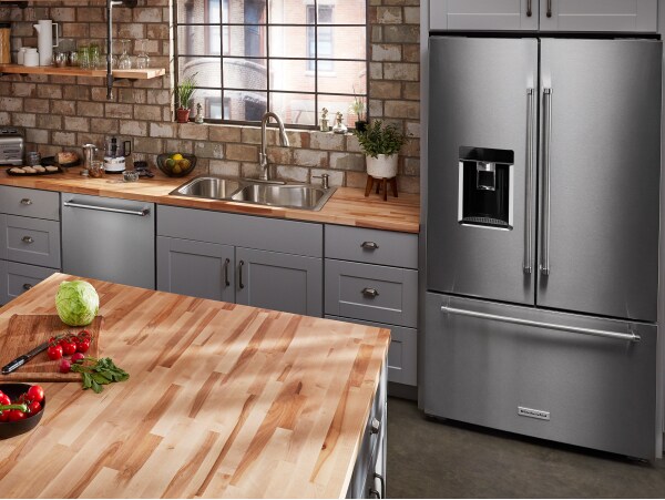 Stainless steel, KitchenAid® French-door refrigerator in gray cabinetry