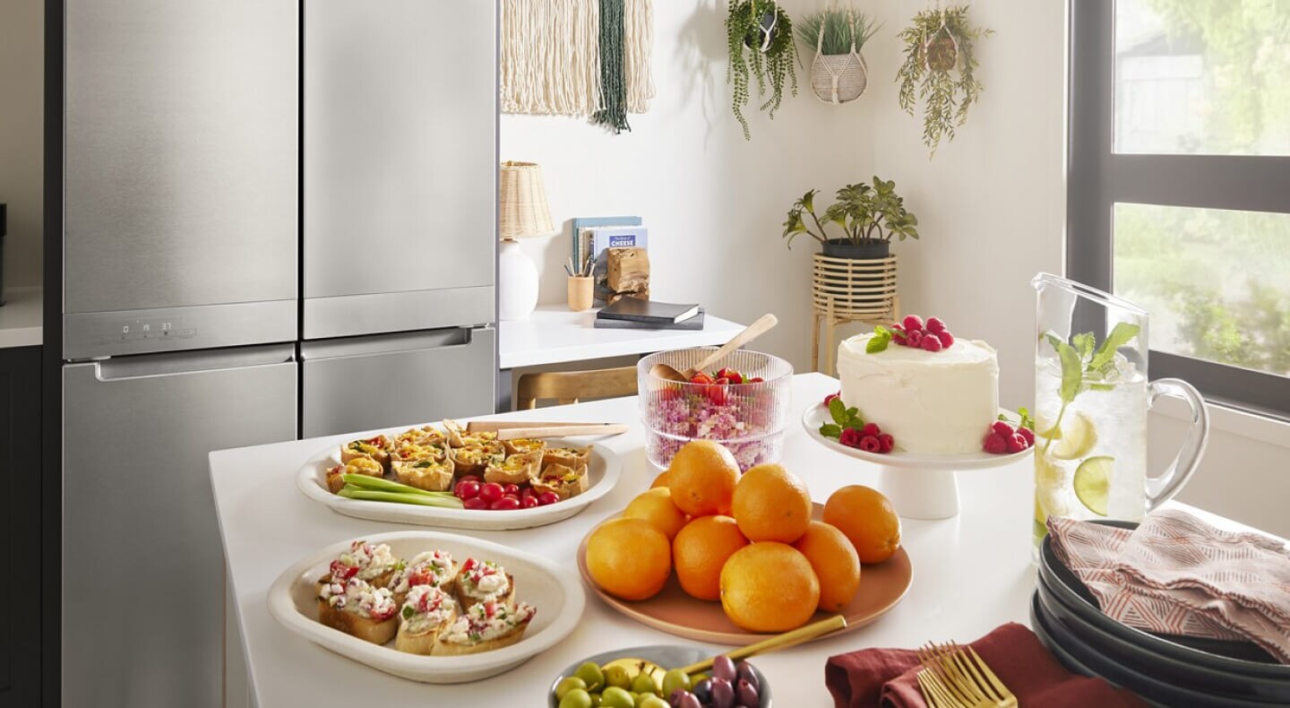 A kitchen with various bright, colorful food arranged on a counter