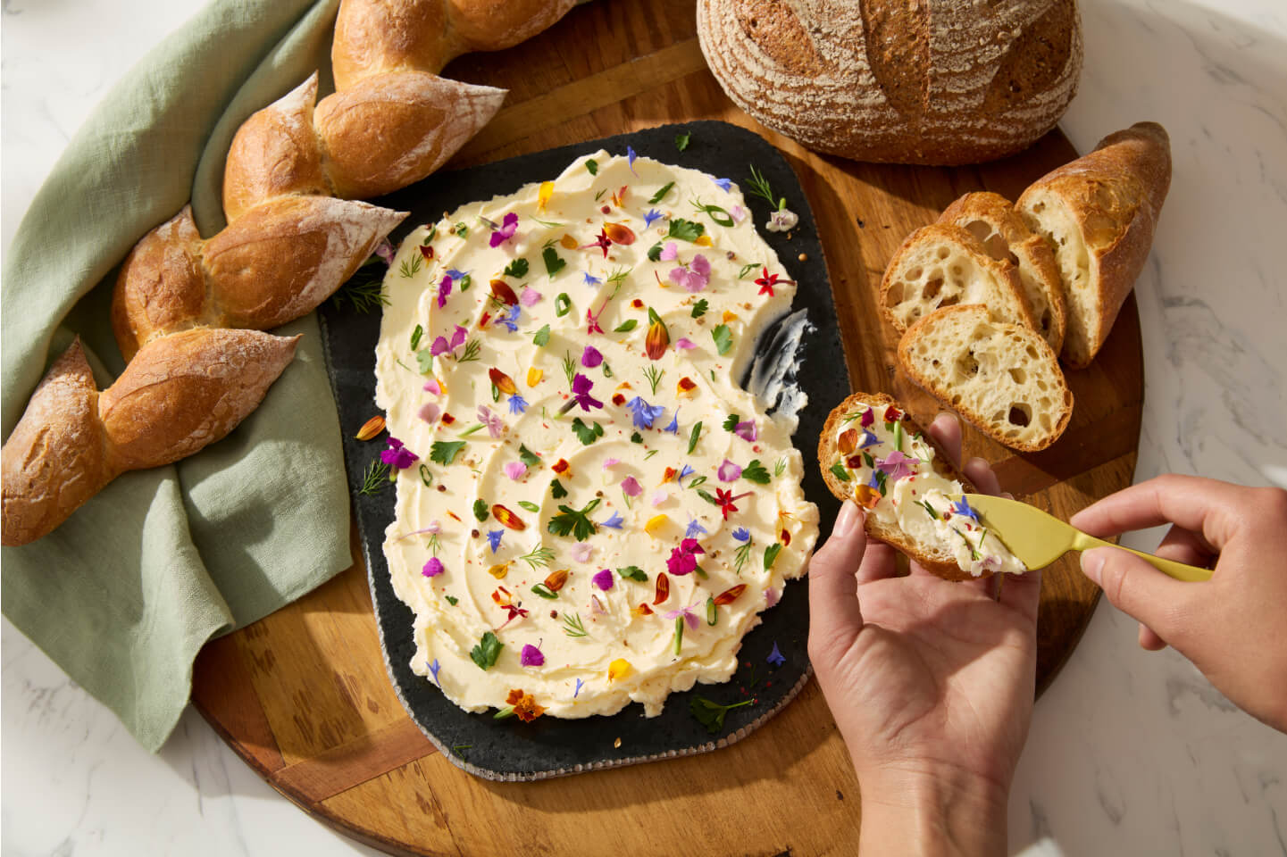 A person spreading butter on crostini. A person spreading butter on crostini.