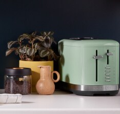 A KitchenAid 2 Slice Toaster against a black backsplash