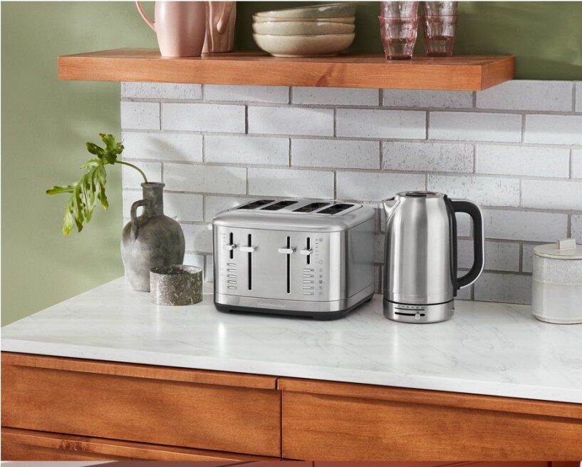 A KitchenAid 4 Slice Toaster on a white countertop against a subway tile backsplash