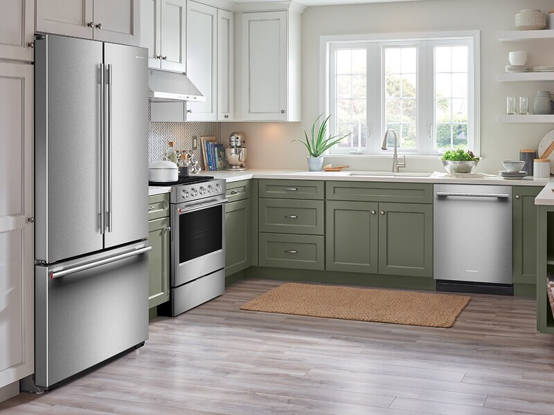 A bright kitchen with white cabinets and stainless steel appliances
