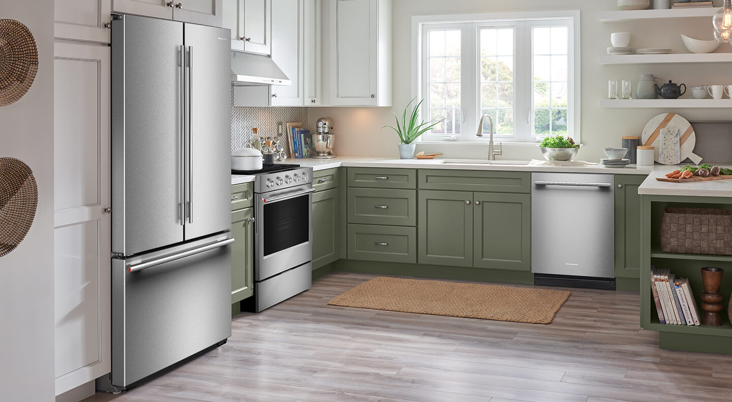 A bright kitchen with white cabinets and stainless steel appliances