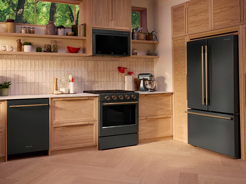 A bright kitchen with wood cabinets and Juniper Kitchenaid® appliances