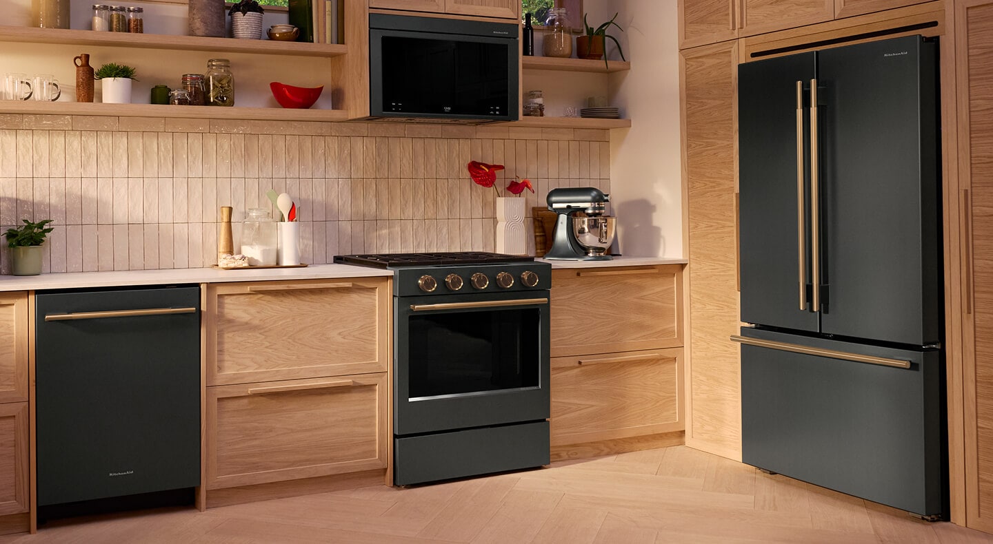 A bright kitchen with wood cabinets and Juniper Kitchenaid® appliances