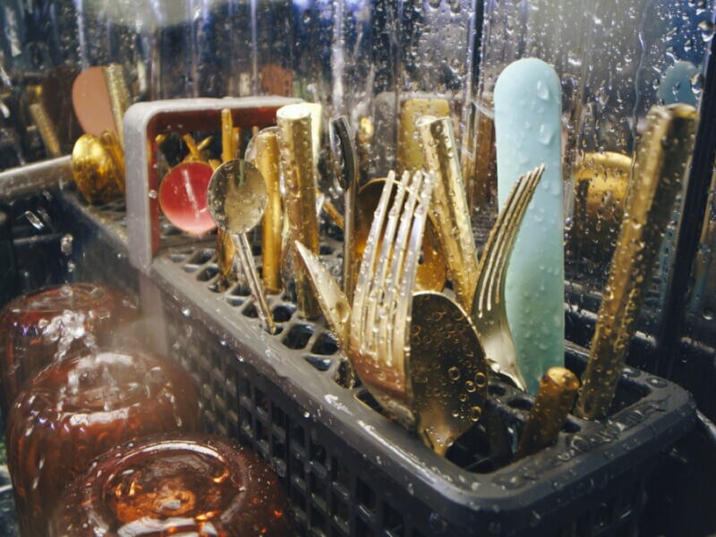 Dishes being cleaned inside a dishwasher