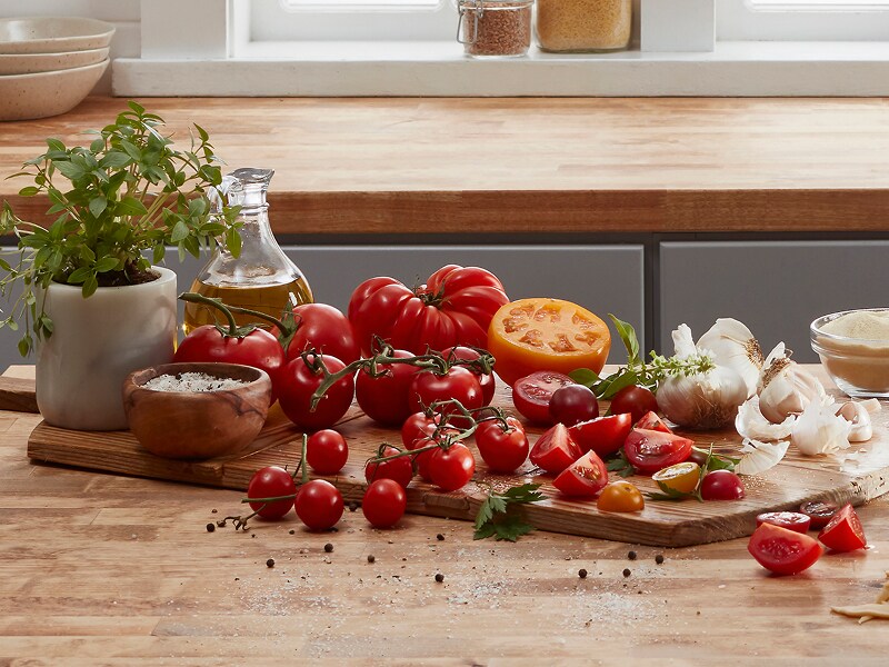 Tomatoes and garlic arranged on a cutting board