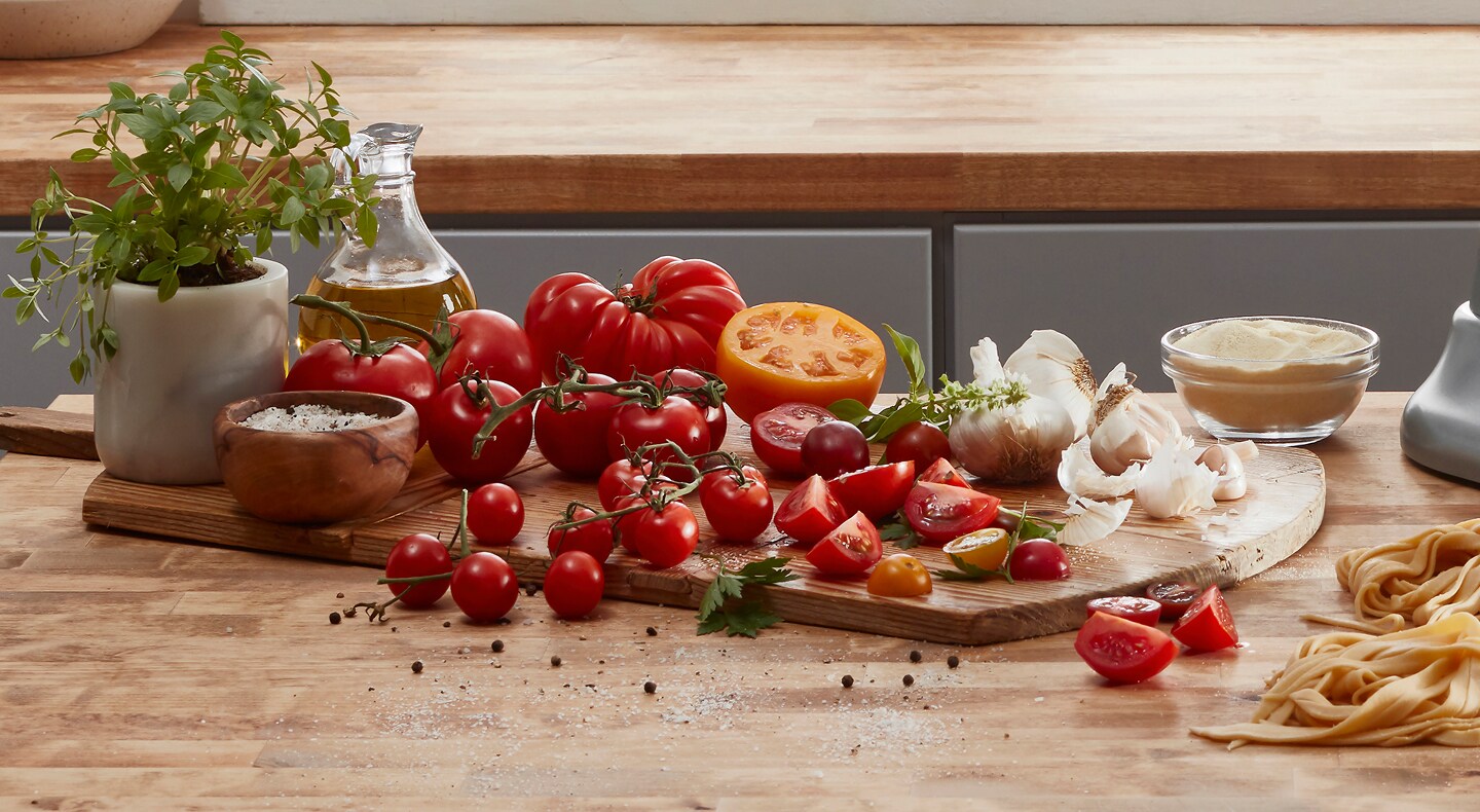 Tomatoes and garlic arranged on a cutting board